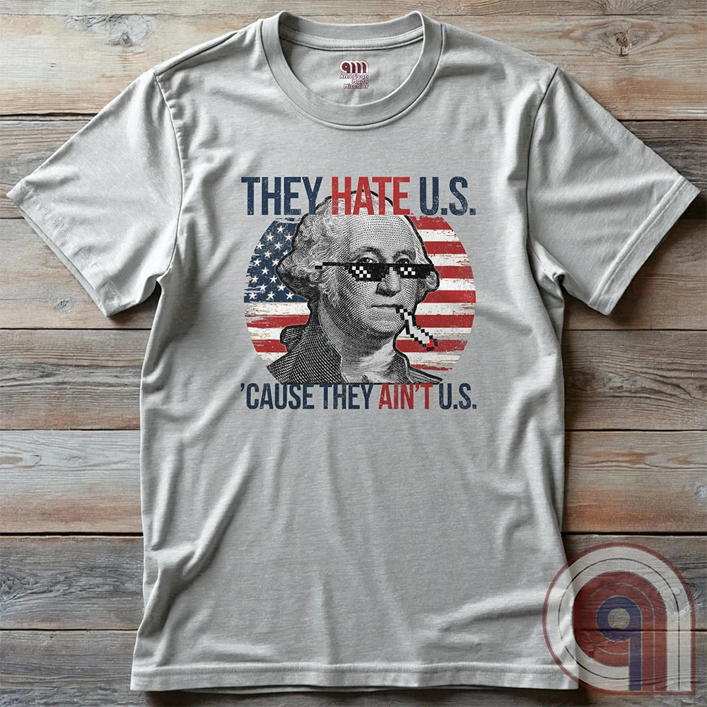 Boldly declare American independence with this They Hate U.S. 'Cause They Ain't U.S. t-shirt - A thug-life George Washington smoking in pixelated shades in front of a distressed American flag. A rebellious thug meme tee that mocks globalists, elitists, and jealous anti-American haters. Perfect for patriots, freedom lovers, & those who embrace the outlaw spirit of 1776. Show your unapologetic pride in American sovereignty, self-reliance, & the right to bear arms with this badass graphic. Color-Ash2