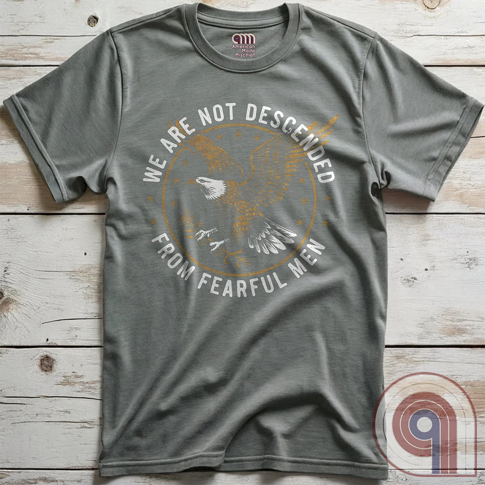 Defy fear and embrace American strength with this bold 'We Are Not Descended from Fearful Men' t-shirt. Featuring a fierce bald eagle, vintage stars, and distressed lettering, this design is a tribute to courage, resilience, & independence. Inspired by the unwavering spirit of the Founding Fathers, this patriotic tee is perfect for veterans, freedom fighters, & anyone who won’t back down. A statement piece for Americans who refuse to live in fear and believe liberty must be defended at all costs; Color:Grey