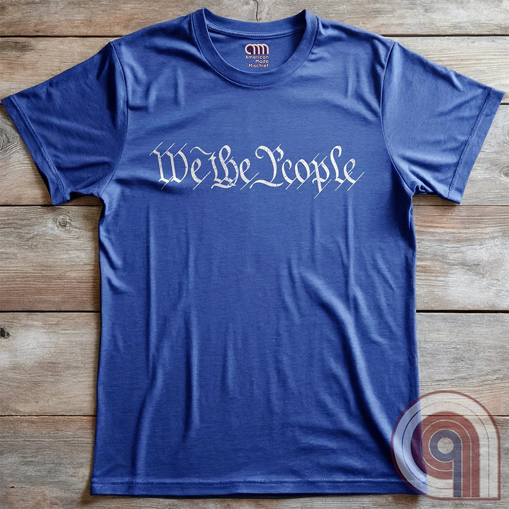 Show your patriotism with this bold 'We The People' t-shirt, inspired by the U.S. Constitution. Featuring classic calligraphy from the founding document, this design represents American freedom, liberty, & the power of the people. Perfect for proud patriots, constitutionalists, & those who stand for individual rights. Celebrate the Bill of Rights, defend the Second Amendment, & stand for limited government with this statement of American values, independence, self-governance, & personal liberty. Color- Blue