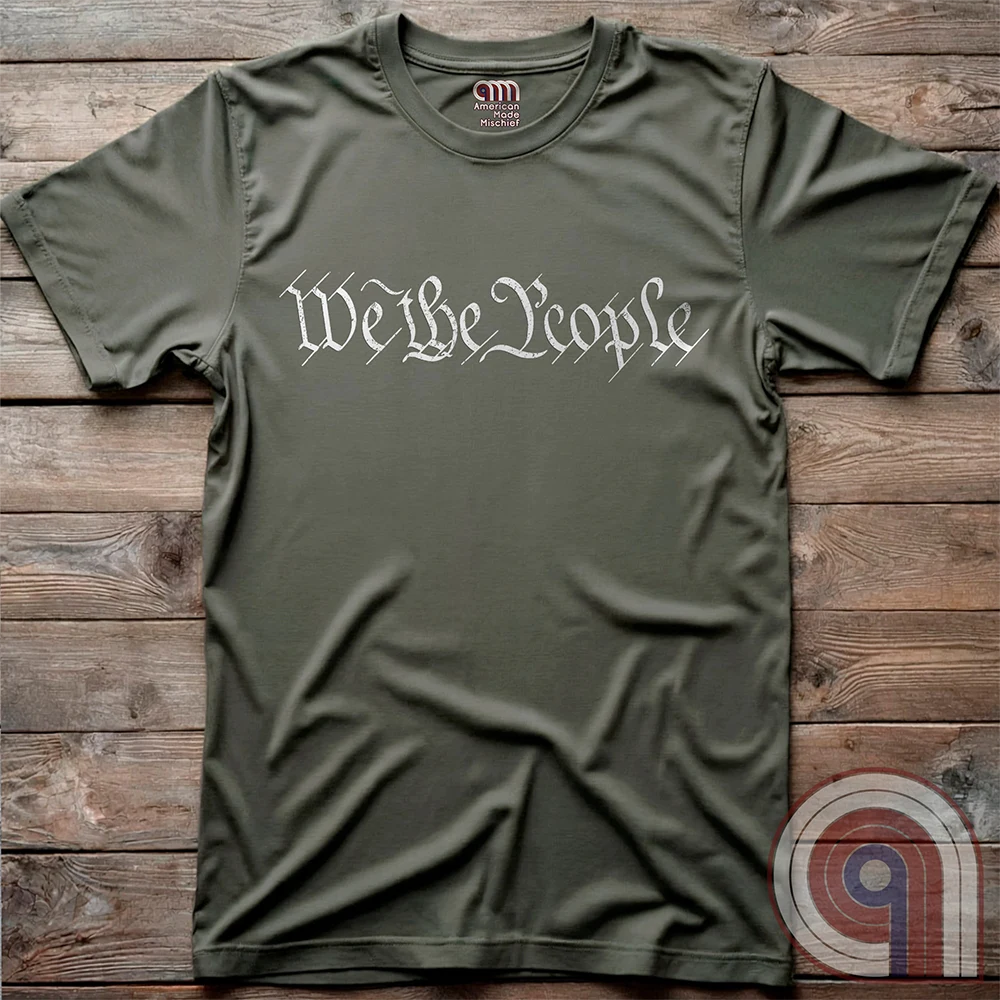 Show your patriotism with this bold 'We The People' t-shirt, inspired by the U.S. Constitution. Featuring classic calligraphy from the founding document, this design represents American freedom, liberty, & the power of the people. Perfect for proud patriots, constitutionalists, & those who stand for individual rights. Celebrate the Bill of Rights, defend the Second Amendment, & stand for limited government with this statement of American values, independence, self-governance, & personal liberty. Color-Green
