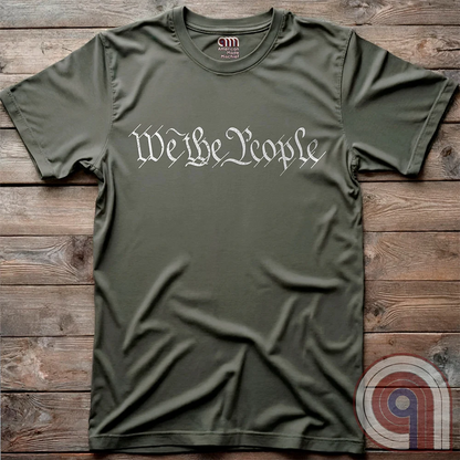 Show your patriotism with this bold 'We The People' t-shirt, inspired by the U.S. Constitution. Featuring classic calligraphy from the founding document, this design represents American freedom, liberty, & the power of the people. Perfect for proud patriots, constitutionalists, & those who stand for individual rights. Celebrate the Bill of Rights, defend the Second Amendment, & stand for limited government with this statement of American values, independence, self-governance, & personal liberty. Color-Green