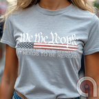 Show your patriotism with this bold 'We The People' t-shirt, featuring the iconic preamble of the U.S. Constitution. With a distressed American flag backdrop, this design is a statement for those who believe in defending the Constitution, freedom, & liberty. Ideal for patriots, conservatives, and constitutionalists who value the Bill of Rights & American history. A must-have for those who oppose government overreach, censorship, and revisionist history. Wear it proudly as a tribute to America. Color: Ash 2