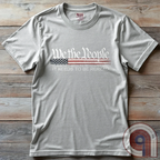Show your patriotism with this bold 'We The People' t-shirt, featuring the iconic preamble of the U.S. Constitution. With a distressed American flag backdrop, this design is a statement for those who believe in defending the Constitution, freedom, & liberty. Ideal for patriots, conservatives, and constitutionalists who value the Bill of Rights & American history. A must-have for those who oppose government overreach, censorship, and revisionist history. Wear it proudly as a tribute to America. Color: Ash