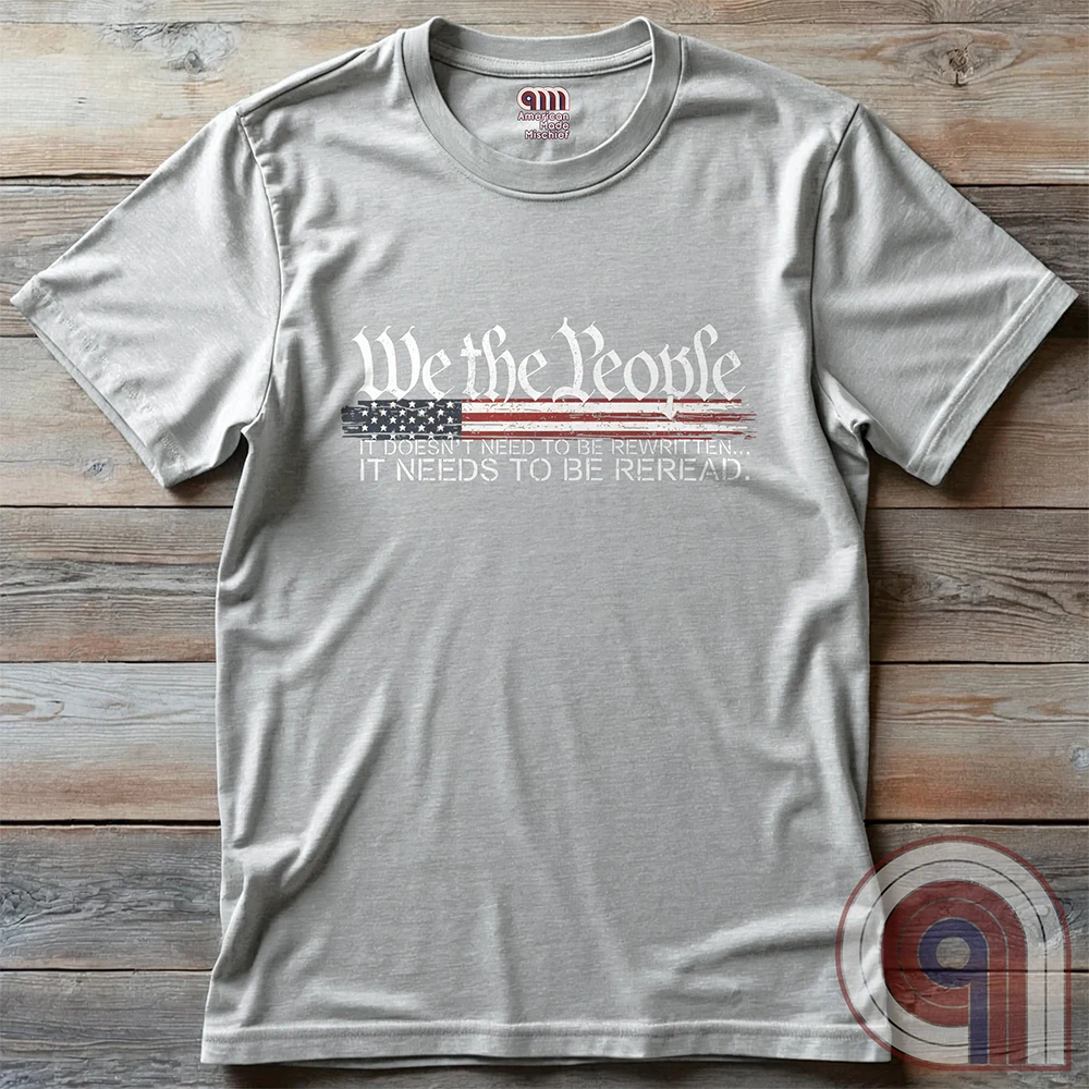 Show your patriotism with this bold 'We The People' t-shirt, featuring the iconic preamble of the U.S. Constitution. With a distressed American flag backdrop, this design is a statement for those who believe in defending the Constitution, freedom, & liberty. Ideal for patriots, conservatives, and constitutionalists who value the Bill of Rights & American history. A must-have for those who oppose government overreach, censorship, and revisionist history. Wear it proudly as a tribute to America. Color: Ash