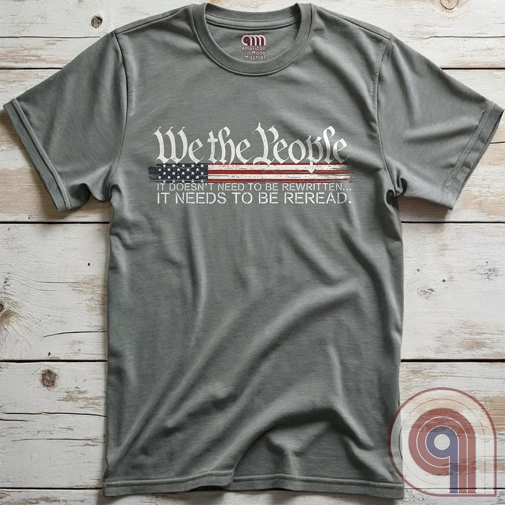 Show your patriotism with this bold 'We The People' t-shirt, featuring the iconic preamble of the U.S. Constitution. With a distressed American flag backdrop, this design is a statement for those who believe in defending the Constitution, freedom, & liberty. Ideal for patriots, conservatives, and constitutionalists who value the Bill of Rights & American history. A must-have for those who oppose government overreach, censorship, and revisionist history. Wear it proudly as a tribute to America. Color: Grey
