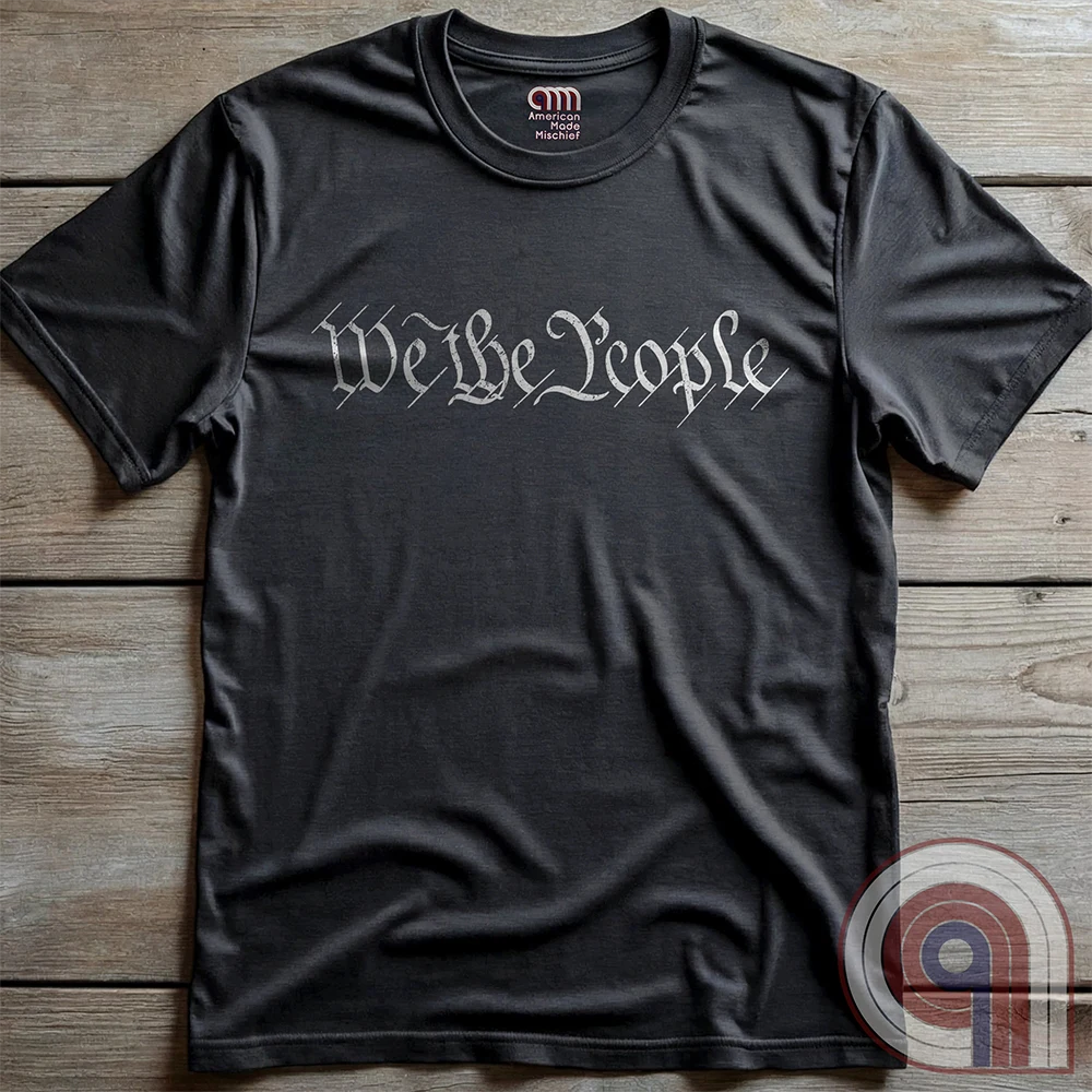 Show your patriotism with this bold 'We The People' t-shirt, inspired by the U.S. Constitution. Featuring classic calligraphy from the founding document, this design represents American freedom, liberty, & the power of the people. Perfect for proud patriots, constitutionalists, & those who stand for individual rights. Celebrate the Bill of Rights, defend the Second Amendment, & stand for limited government with this statement of American values, independence, self-governance, & personal liberty. Color-Char