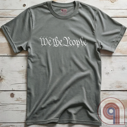 Show your patriotism with this bold 'We The People' t-shirt, inspired by the U.S. Constitution. Featuring classic calligraphy from the founding document, this design represents American freedom, liberty, & the power of the people. Perfect for proud patriots, constitutionalists, & those who stand for individual rights. Celebrate the Bill of Rights, defend the Second Amendment, & stand for limited government with this statement of American values, independence, self-governance, & personal liberty. Color- Grey