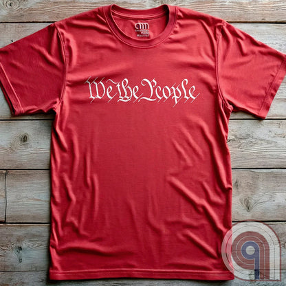 Show your patriotism with this bold 'We The People' t-shirt, inspired by the U.S. Constitution. Featuring classic calligraphy from the founding document, this design represents American freedom, liberty, & the power of the people. Perfect for proud patriots, constitutionalists, & those who stand for individual rights. Celebrate the Bill of Rights, defend the Second Amendment, & stand for limited government with this statement of American values, independence, self-governance, & personal liberty. Color- Red