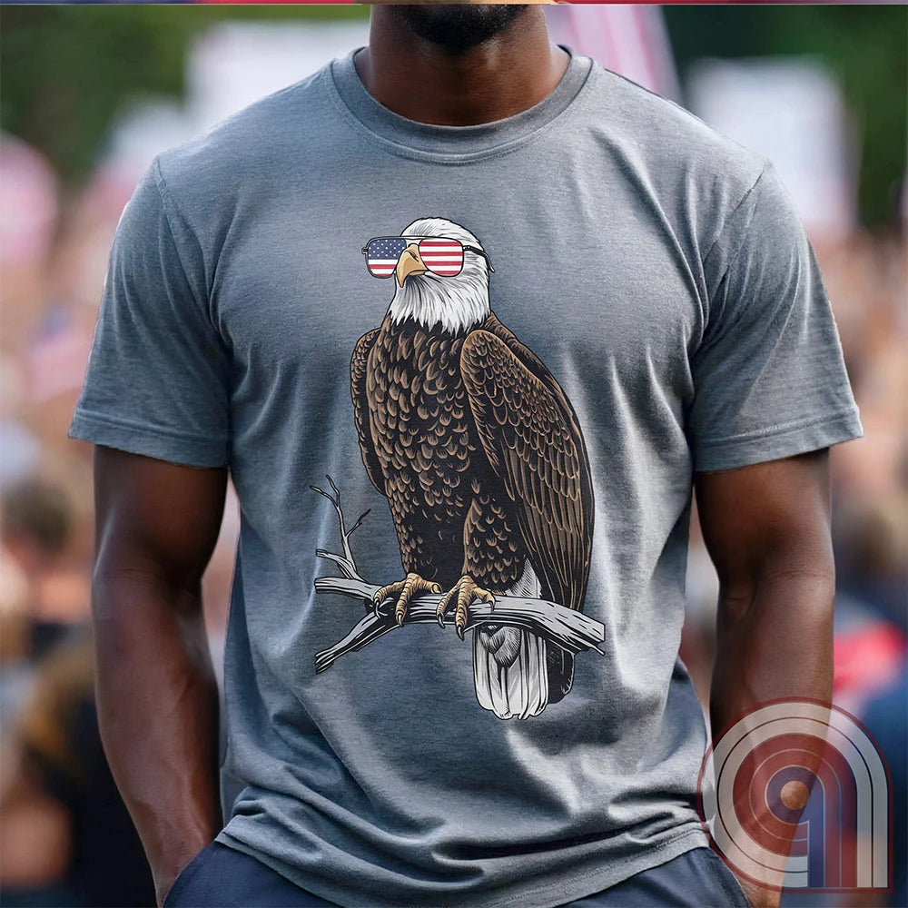 Declare your independence with this striking Pro USA t-shirt featuring America’s ultimate symbol of freedom—the bald eagle—sporting American flag sunglasses. It’s not just a patriotic tee—it’s a statement of strength, sovereignty, and pride. 
Bald eagle t-shirt;Patriotic eagle shirt;American flag sunglasses design;USA freedom shirt;Pro-America graphic tee;Unisex patriotic t-shirt;Eagle with American flag glasses shirt;Conservative values;July 4th eagle t-shirt;USA-made freedom apparel;MAGA;1776; - Grey