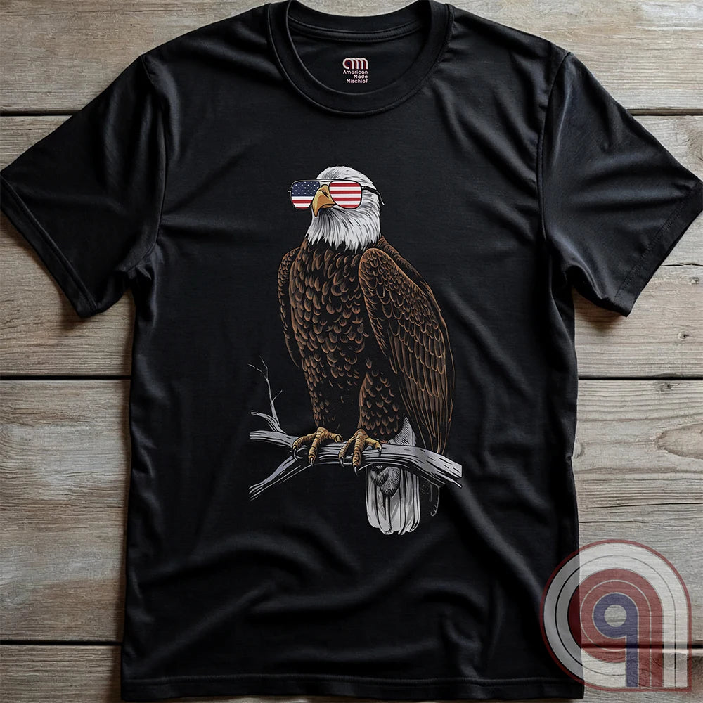 Declare your independence with this striking Pro USA t-shirt featuring America’s ultimate symbol of freedom—the bald eagle—sporting American flag sunglasses. It’s not just a patriotic tee—it’s a statement of strength, sovereignty, and pride. 
Bald eagle t-shirt;Patriotic eagle shirt;American flag sunglasses design;USA freedom shirt;Pro-America graphic tee;Unisex patriotic t-shirt;Eagle with American flag glasses shirt;Conservative values;July 4th eagle t-shirt;USA-made freedom apparel;MAGA;1776; - Charcoal