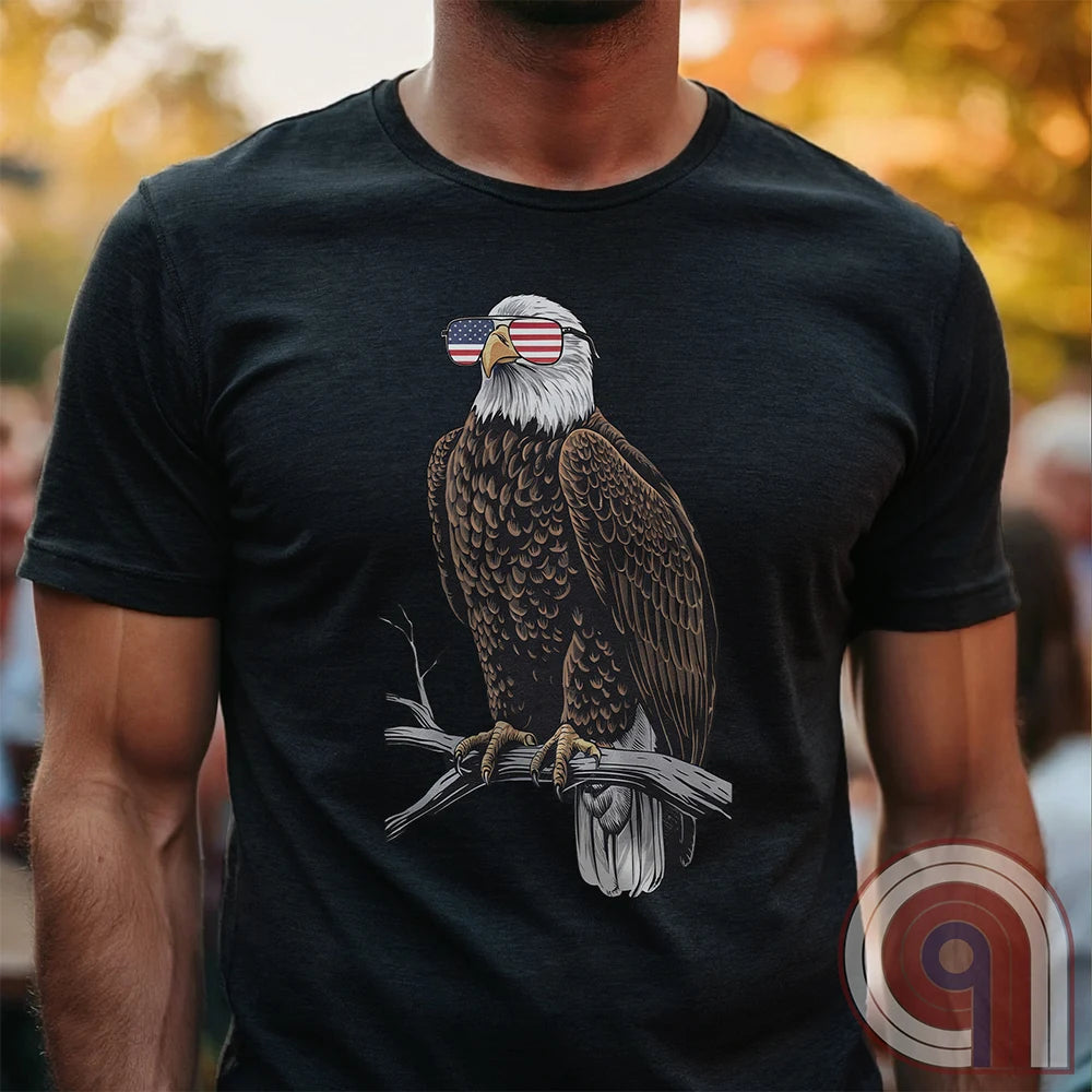 Declare your independence with this striking Pro USA t-shirt featuring America’s ultimate symbol of freedom—the bald eagle—sporting American flag sunglasses. It’s not just a patriotic tee—it’s a statement of strength, sovereignty, and pride. 
Bald eagle t-shirt;Patriotic eagle shirt;American flag sunglasses design;USA freedom shirt;Pro-America graphic tee;Unisex patriotic t-shirt;Eagle with American flag glasses shirt;Conservative values;July 4th eagle t-shirt;USA-made freedom apparel;MAGA;1776; - Charcoal
