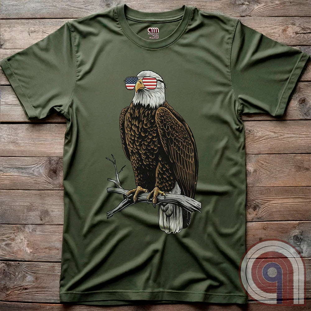 Declare your independence with this striking Pro USA t-shirt featuring America’s ultimate symbol of freedom—the bald eagle—sporting American flag sunglasses. It’s not just a patriotic tee—it’s a statement of strength, sovereignty, and pride. 
Bald eagle t-shirt;Patriotic eagle shirt;American flag sunglasses design;USA freedom shirt;Pro-America graphic tee;Unisex patriotic t-shirt;Eagle with American flag glasses shirt;Conservative values;July 4th eagle t-shirt;USA-made freedom apparel;MAGA;1776; - Green