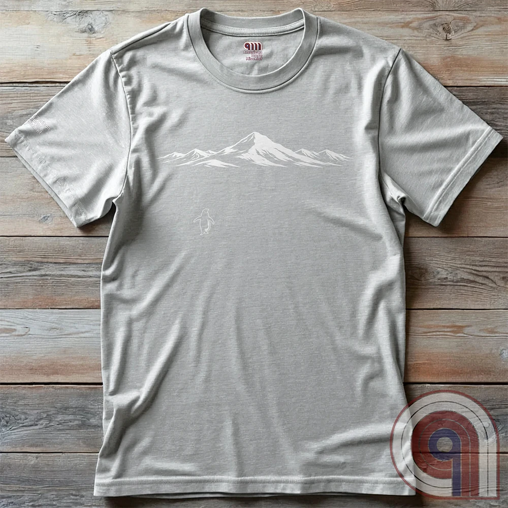 Minimalist inspirational t-shirt graphic showing a lone penguin walking away beneath a vast snow-covered mountain range, inspired by Werner Herzog’s wandering penguin documentary scene. This Tee evokes existential solitude, Faustian spirit, nihilism, faith, and quiet bravery, symbolizing the call to adventure, isolation, perseverance, philosophy, and the human search for meaning through nature, exploration, and understated surreal meme culture.
Ash
