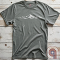 Minimalist inspirational t-shirt graphic showing a lone penguin walking away beneath a vast snow-covered mountain range, inspired by Werner Herzog’s wandering penguin documentary scene. This Tee evokes existential solitude, Faustian spirit, nihilism, faith, and quiet bravery, symbolizing the call to adventure, isolation, perseverance, philosophy, and the human search for meaning through nature, exploration, and understated surreal meme culture.
Grey