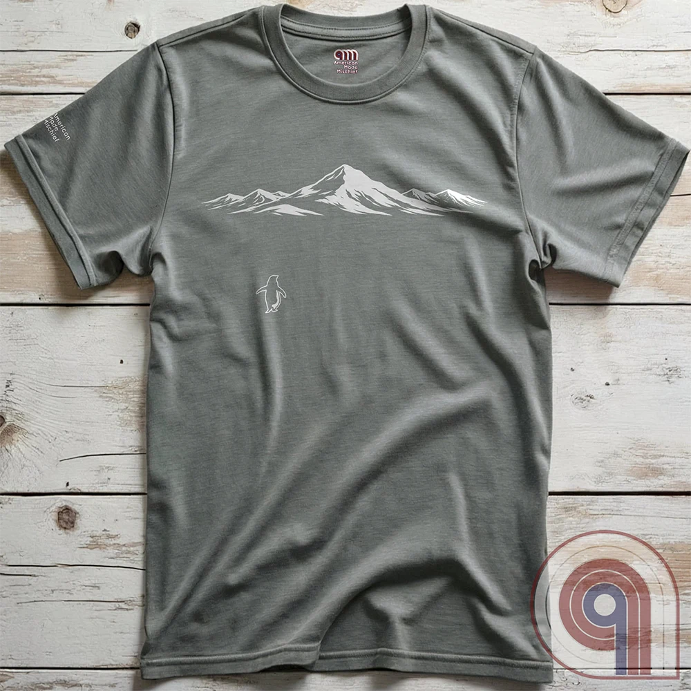 Minimalist inspirational t-shirt graphic showing a lone penguin walking away beneath a vast snow-covered mountain range, inspired by Werner Herzog’s wandering penguin documentary scene. This Tee evokes existential solitude, Faustian spirit, nihilism, faith, and quiet bravery, symbolizing the call to adventure, isolation, perseverance, philosophy, and the human search for meaning through nature, exploration, and understated surreal meme culture.
Grey