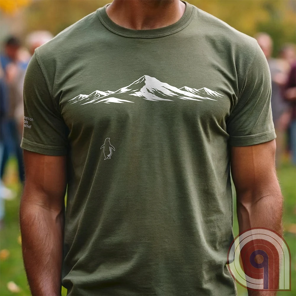 Minimalist inspirational t-shirt graphic showing a lone penguin walking away beneath a vast snow-covered mountain range, inspired by Werner Herzog’s wandering penguin documentary scene. This Tee evokes existential solitude, Faustian spirit, nihilism, faith, and quiet bravery, symbolizing the call to adventure, isolation, perseverance, philosophy, and the human search for meaning through nature, exploration, and understated surreal meme culture. Green
