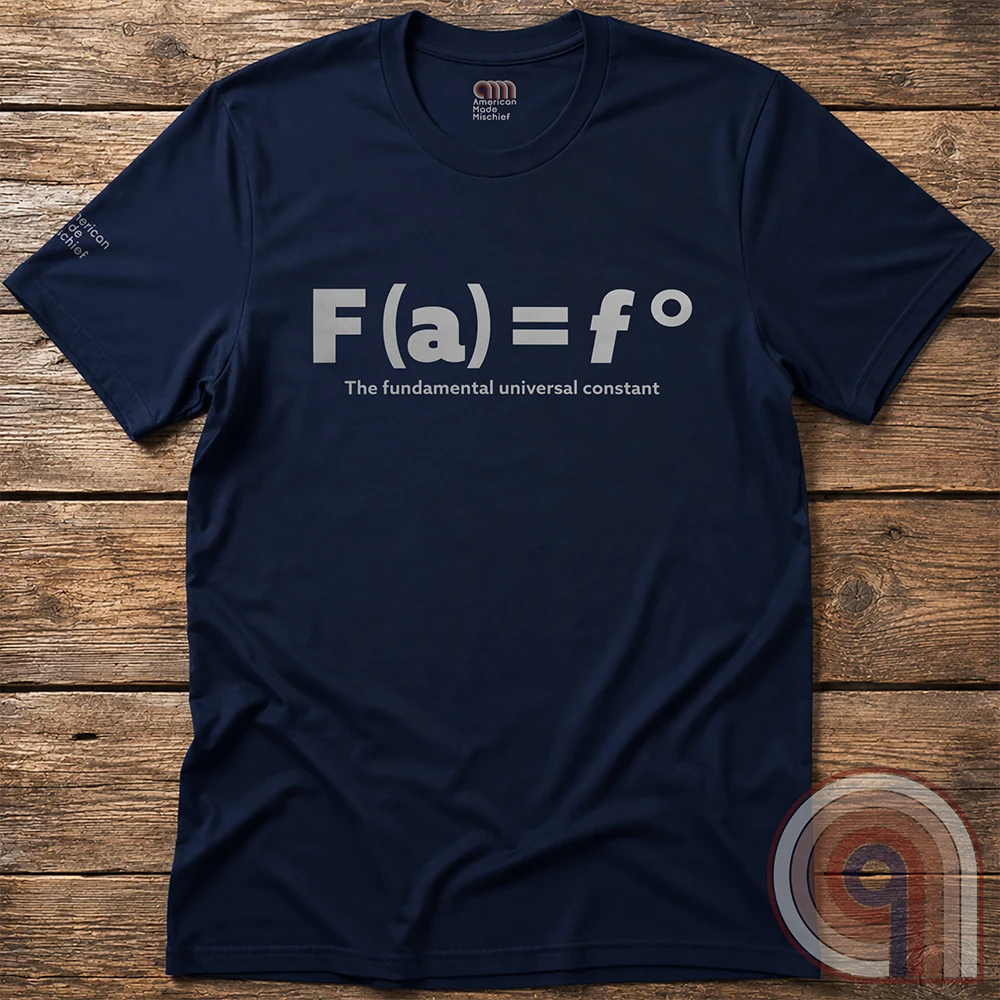 Navy T-shirt shown flat on wood with a centered pale equation, “F(a) = f°,” over the words “The fundamental universal constant”.
