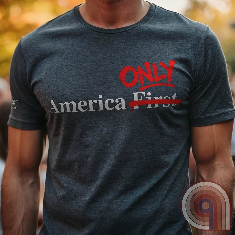 Charcoal tee on a model with “America First” across the chest, the word “First” crossed out and bright red handwritten “ONLY” inserted above—a stark America Only edit.