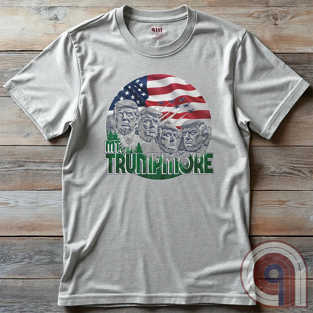 Mount Trumpmore stands as a bold symbol of American resilience, patriotism, and leadership. This striking t-shirt reimagines a national monument in the image of Donald Trump, embodying strength, defiance, & commitment to America first. Set against the stars & stripes, this shirt captures the grandeur of a historical moment & the glory of a triumphant return. For patriots who refuse to let America fade, this tee celebrates leadership and a vision of American greatness carved into history. Color- Ash2