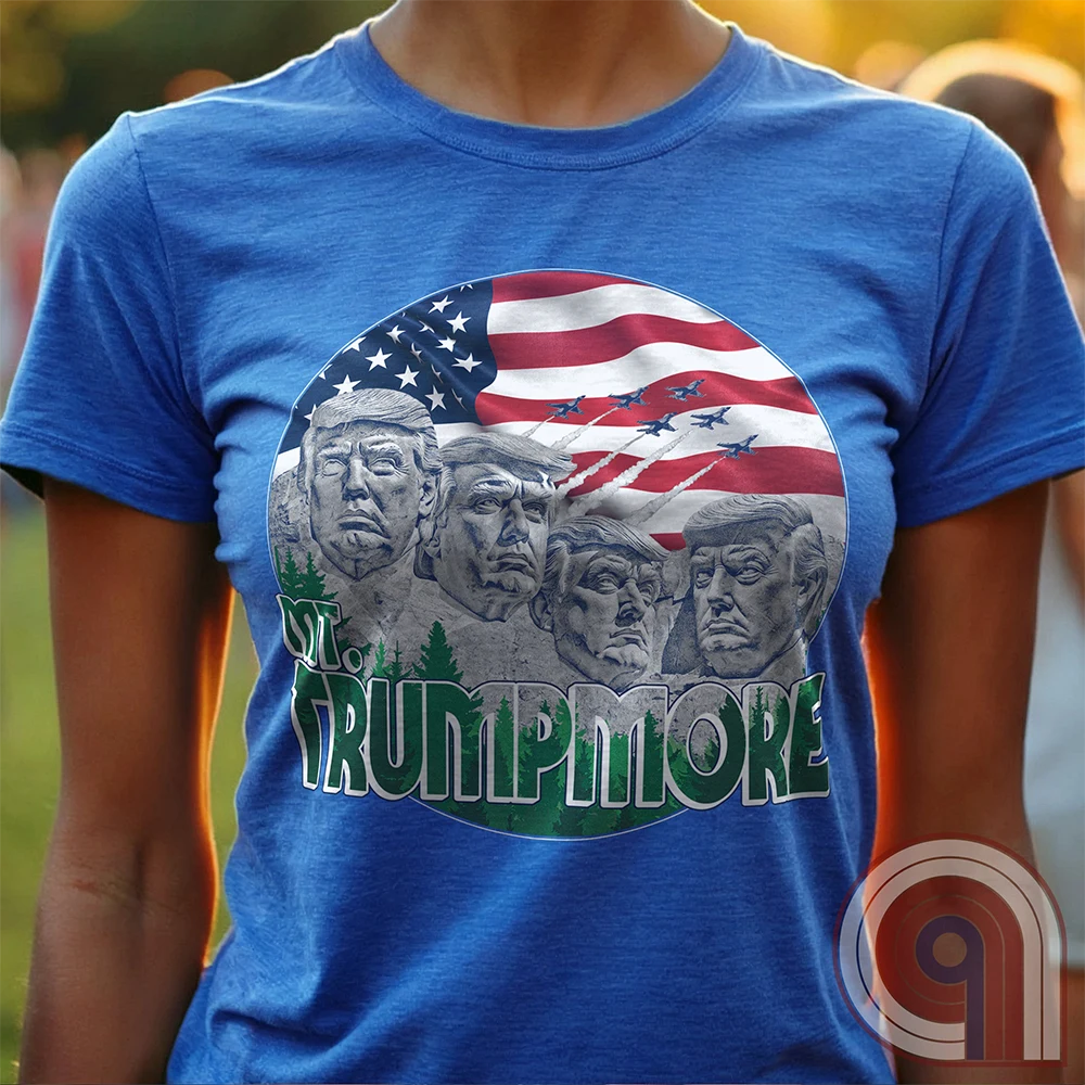 Mount Trumpmore stands as a bold symbol of American resilience, patriotism, and leadership. This striking t-shirt reimagines a national monument in the image of Donald Trump, embodying strength, defiance, & commitment to America first. Set against the stars & stripes, this shirt captures the grandeur of a historical moment & the glory of a triumphant return. For patriots who refuse to let America fade, this tee celebrates leadership and a vision of American greatness carved into history. Color- Blue1