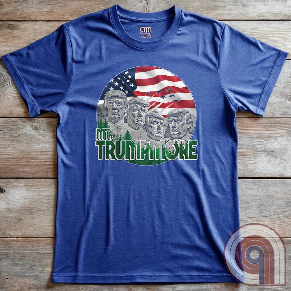 Mount Trumpmore stands as a bold symbol of American resilience, patriotism, and leadership. This striking t-shirt reimagines a national monument in the image of Donald Trump, embodying strength, defiance, & commitment to America first. Set against the stars & stripes, this shirt captures the grandeur of a historical moment & the glory of a triumphant return. For patriots who refuse to let America fade, this tee celebrates leadership and a vision of American greatness carved into history. Color- Blue2