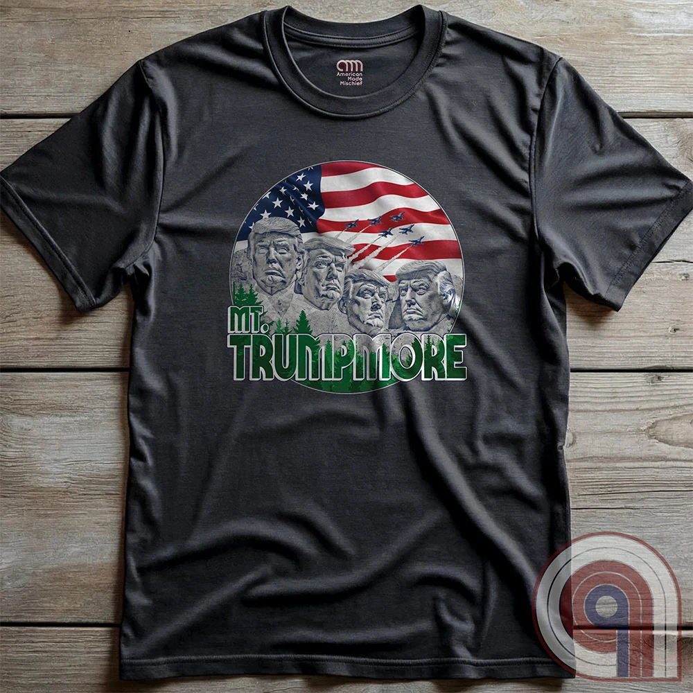 Mount Trumpmore stands as a bold symbol of American resilience, patriotism, and leadership. This striking t-shirt reimagines a national monument in the image of Donald Trump, embodying strength, defiance, & commitment to America first. Set against the stars & stripes, this shirt captures the grandeur of a historical moment & the glory of a triumphant return. For patriots who refuse to let America fade, this tee celebrates leadership and a vision of American greatness carved into history. Color- Charc2