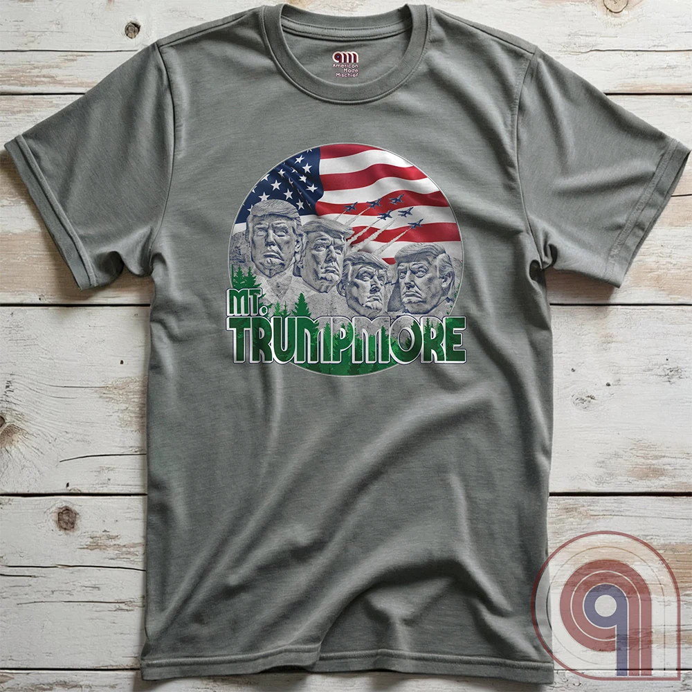 Mount Trumpmore stands as a bold symbol of American resilience, patriotism, and leadership. This striking t-shirt reimagines a national monument in the image of Donald Trump, embodying strength, defiance, & commitment to America first. Set against the stars & stripes, this shirt captures the grandeur of a historical moment & the glory of a triumphant return. For patriots who refuse to let America fade, this tee celebrates leadership and a vision of American greatness carved into history. Color- Grey2