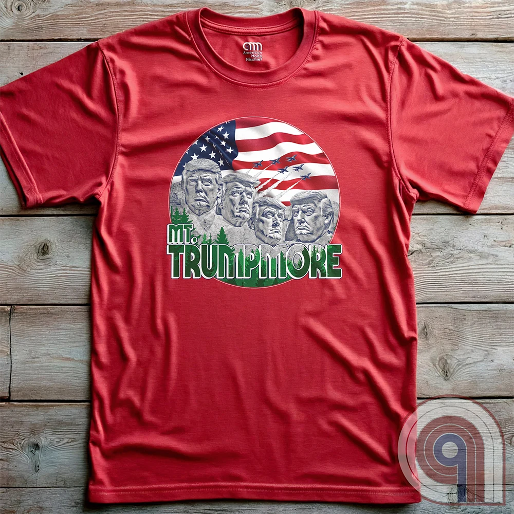 Mount Trumpmore stands as a bold symbol of American resilience, patriotism, and leadership. This striking t-shirt reimagines a national monument in the image of Donald Trump, embodying strength, defiance, & commitment to America first. Set against the stars & stripes, this shirt captures the grandeur of a historical moment & the glory of a triumphant return. For patriots who refuse to let America fade, this tee celebrates leadership and a vision of American greatness carved into history. Color- Red2