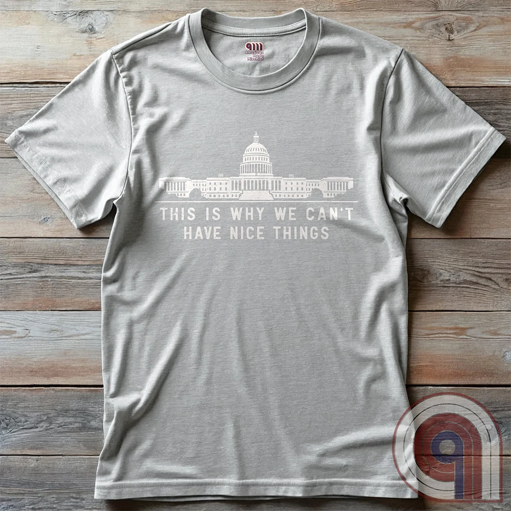 "This Is Why We Can't Have Nice Things" political satire t-shirt exposing congressional corruption, government waste, & the reckless mismanagement of American resources. Featuring bold typography and a minimalist design, this anti-establishment tee makes a statement against fraud, bureaucratic incompetence, & the squandering of taxpayer dollars. A must-have for those who demand accountability & transparency from elected officials. Wear it loud and proud to call out the system’s failures. Color- Ash2