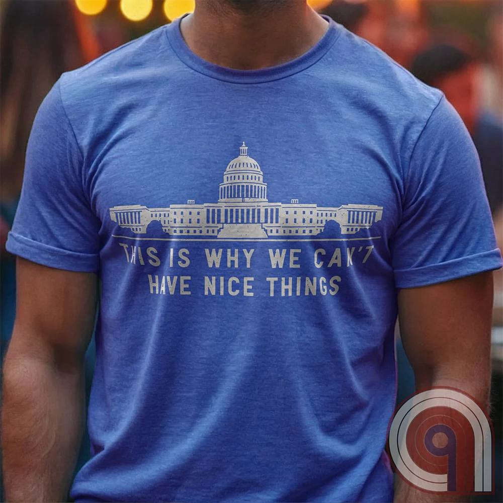 "This Is Why We Can't Have Nice Things" political satire t-shirt exposing congressional corruption, government waste, & the reckless mismanagement of American resources. Featuring bold typography and a minimalist design, this anti-establishment tee makes a statement against fraud, bureaucratic incompetence, & the squandering of taxpayer dollars. A must-have for those who demand accountability & transparency from elected officials. Wear it loud and proud to call out the system’s failures. Color- Blue1