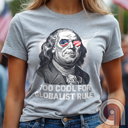 Bold and electrifying, this Too Cool for Globalist Rule t-shirt features Ben Franklin rocking patriotic American flag sunglasses, radiating defiance against tyranny. With a lightning bolt in the backdrop, this anti-globalist, pro-sovereignty design embodies the rebellious spirit of American independence. Inspired by Franklin’s quote “Rebellion to tyrants is obedience to God”, this patriotic tee is a warning to globalist elites, communists, and tyrants—freedom-loving Americans won’t kneel. Color- Ash1