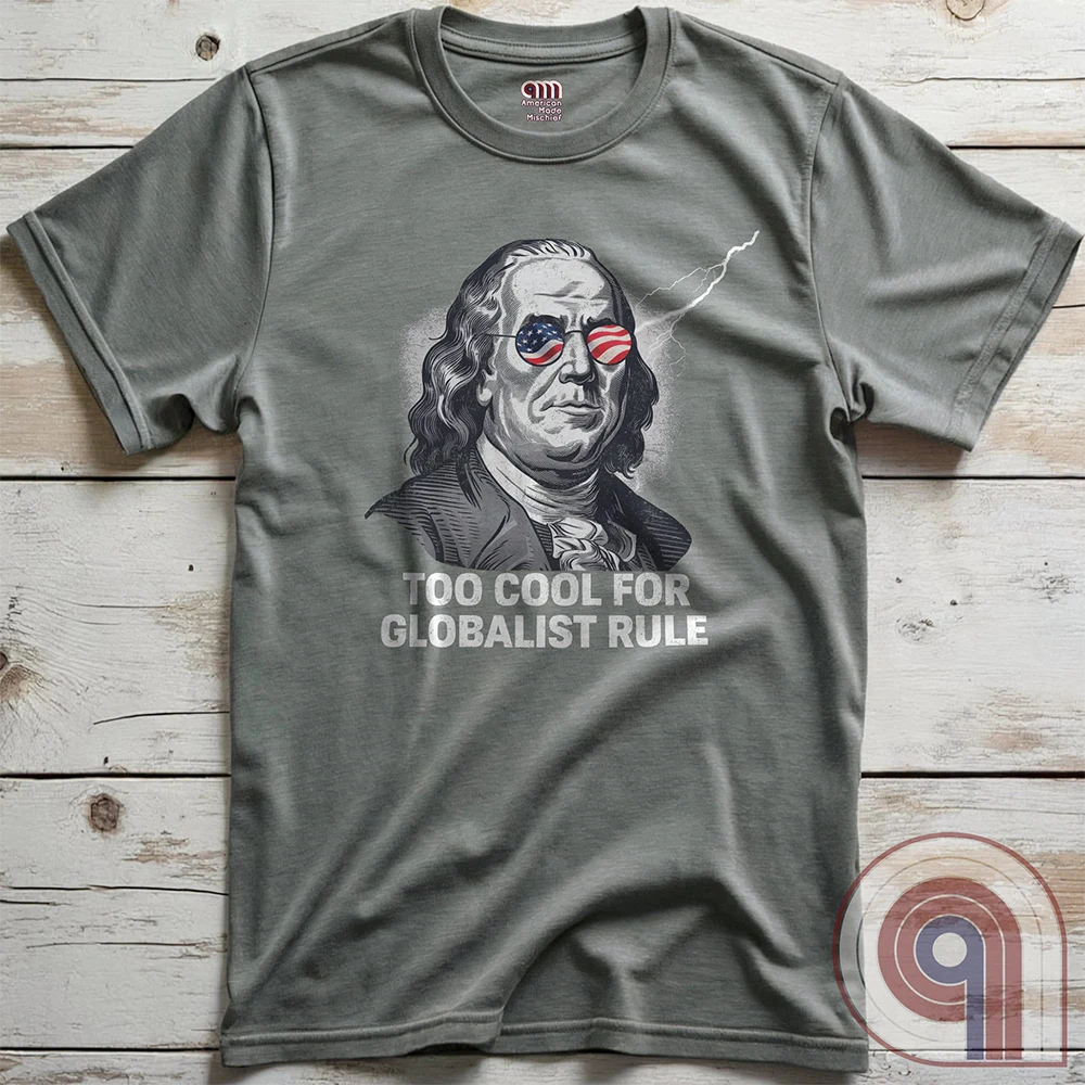 Bold and electrifying, this Too Cool for Globalist Rule t-shirt features Ben Franklin rocking patriotic American flag sunglasses, radiating defiance against tyranny. With a lightning bolt in the backdrop, this anti-globalist, pro-sovereignty design embodies the rebellious spirit of American independence. Inspired by Franklin’s quote “Rebellion to tyrants is obedience to God”, this patriotic tee is a warning to globalist elites, communists, and tyrants—freedom-loving Americans won’t kneel. Color- Grey2